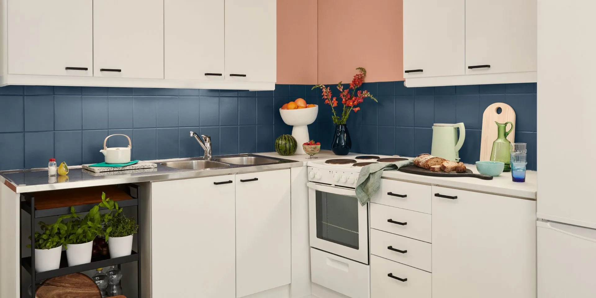 white kitchen with blue painted backsplash tiles